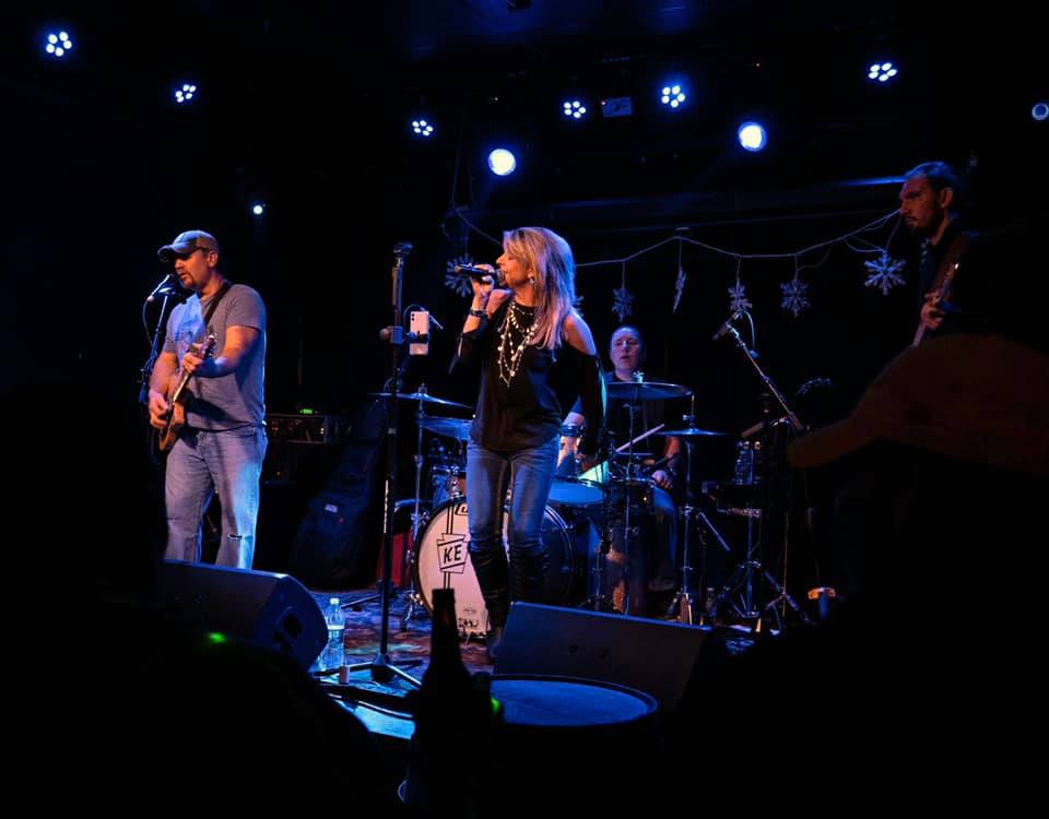 A group of people on stage performing.