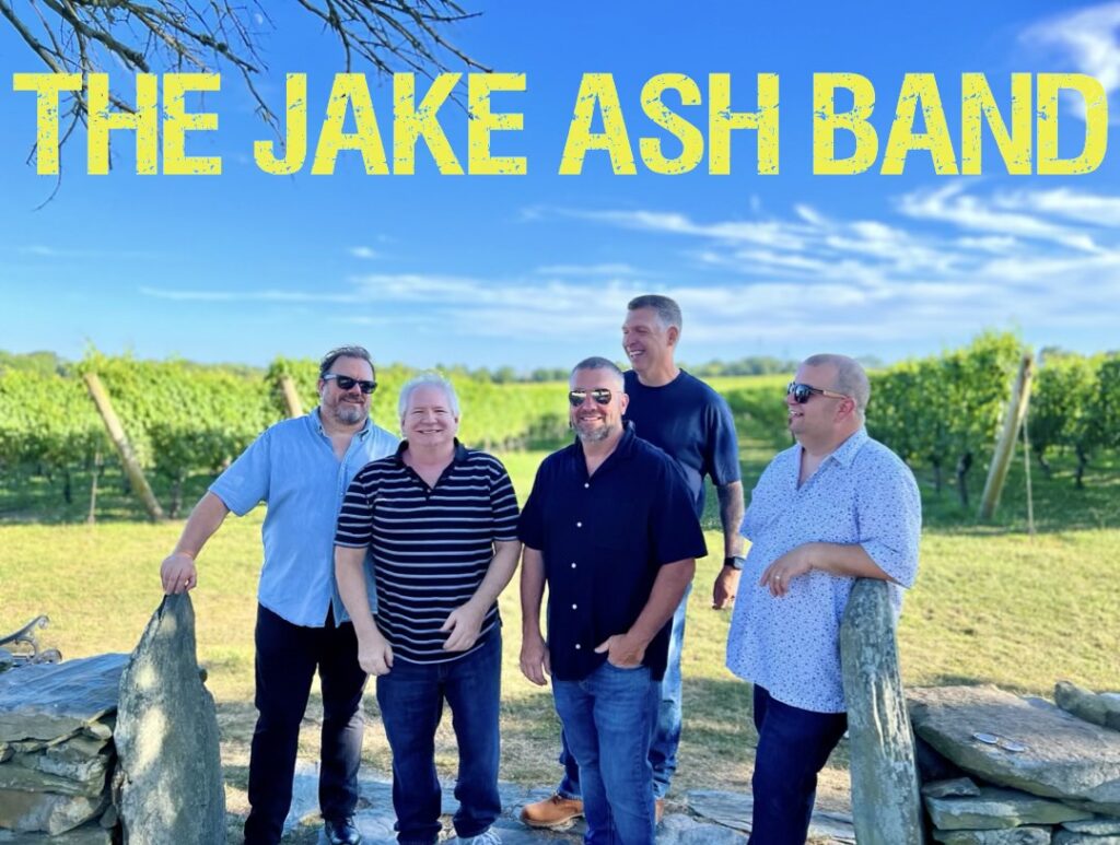 A group of men standing in front of some trees.