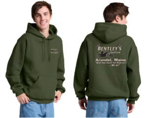 Man wearing an olive green hoodie with printed text on front and back.